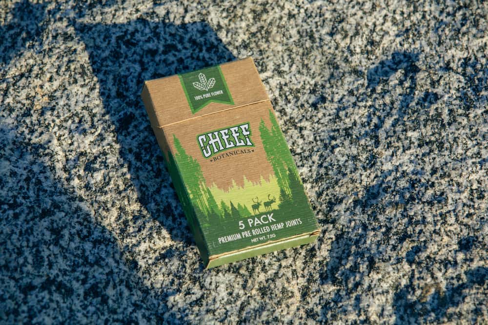 pack of pre-rolls on rock at beach