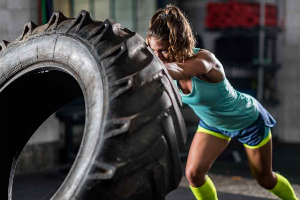 athlete flipping tire for workout