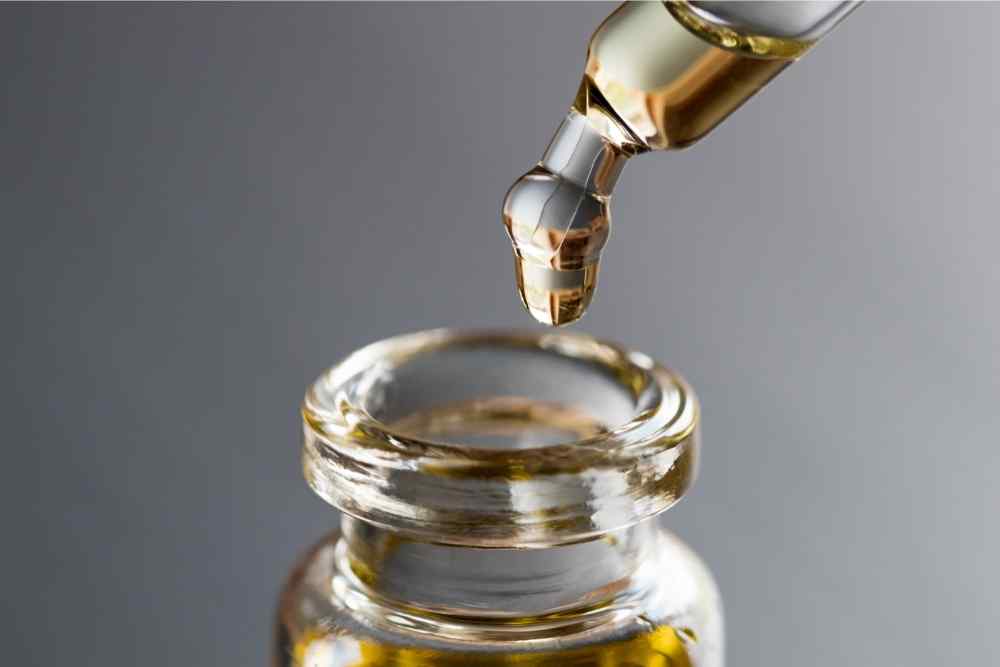 dropping essential oil into bottle