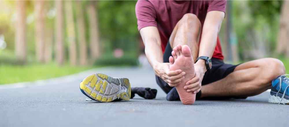 runner holding foot in pain