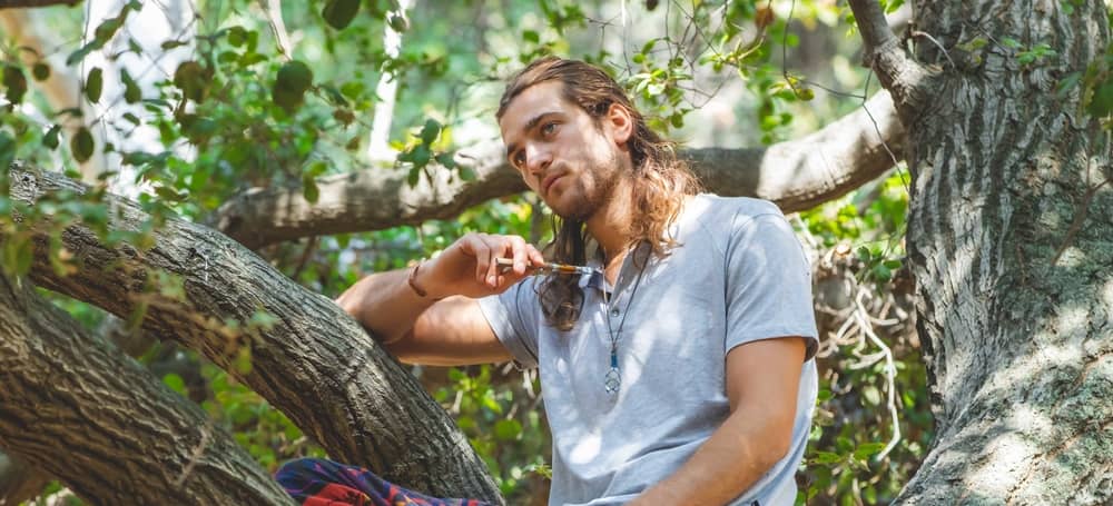matias vaping in a tree in woods