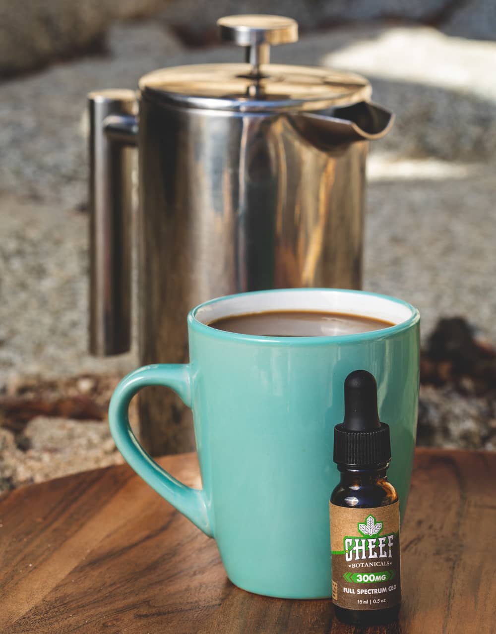 cbd tincture and coffee next to pot