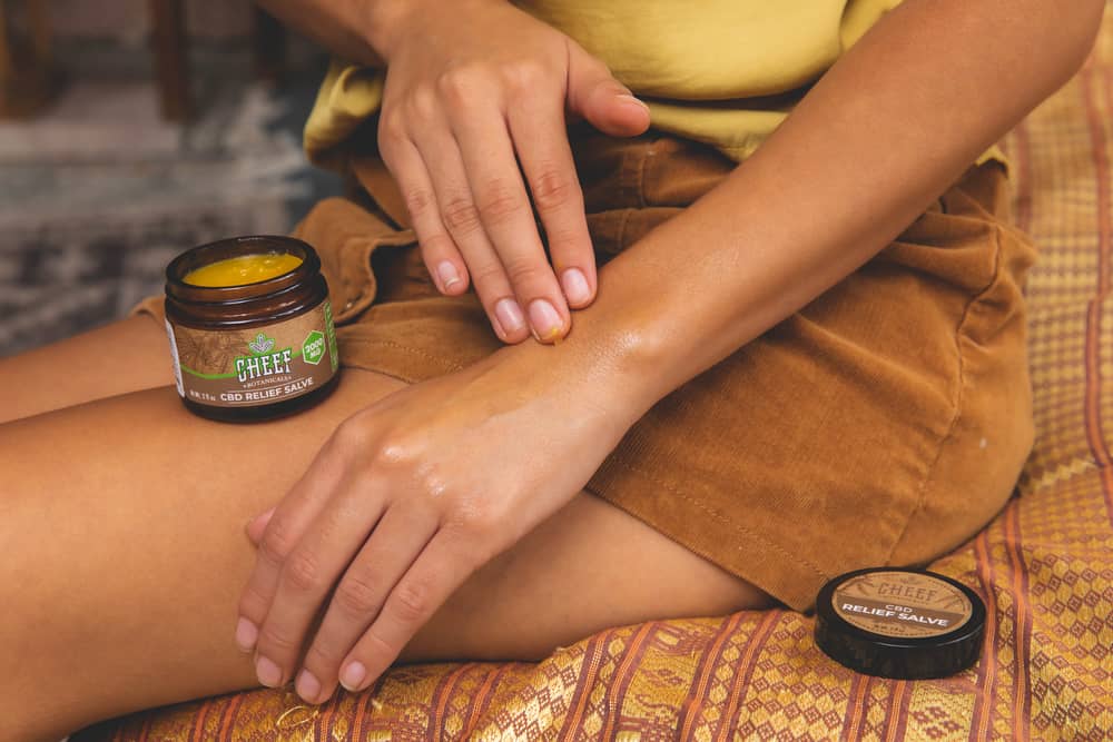 girl applying hemp topical to arm