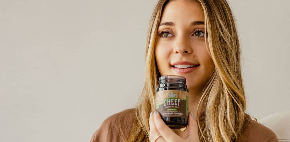 smelling hemp flower from glass jar