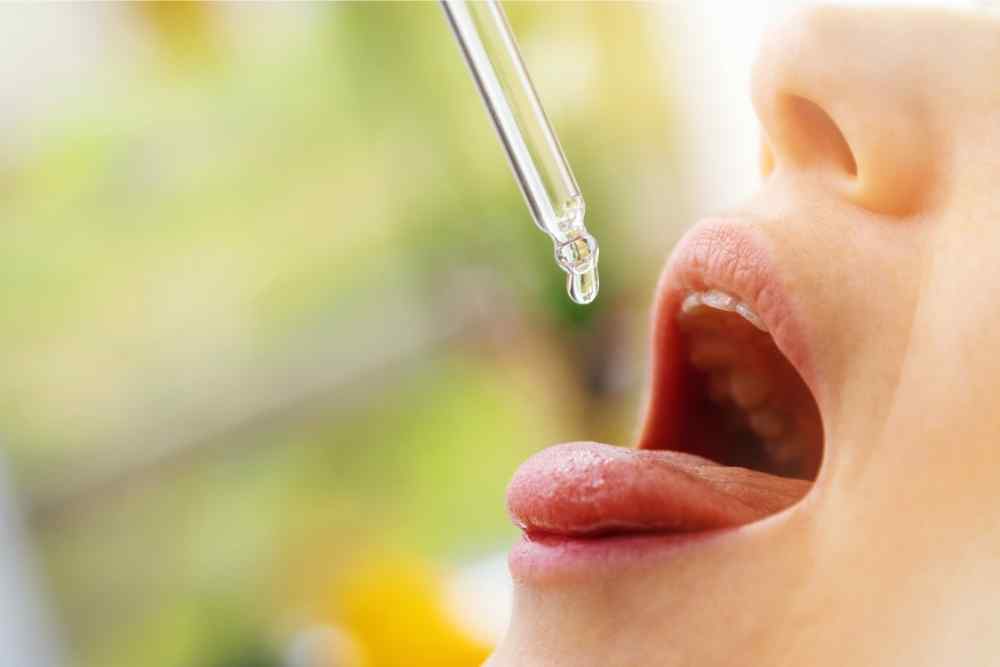 dropping cbd oil into mouth