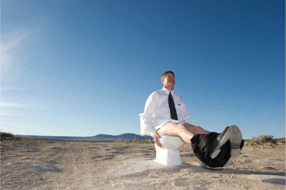 man pooping in the middle of nowhere