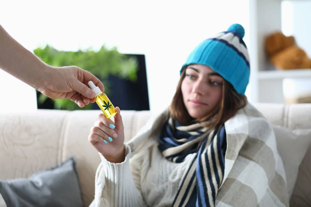 sick woman using cbd oil