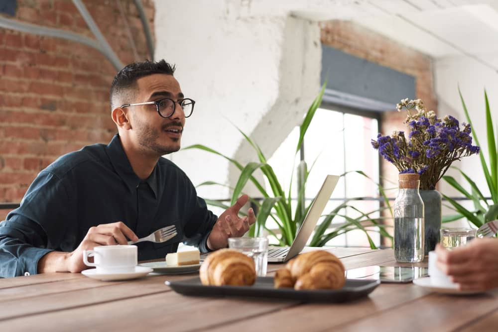 photo of man in front of his laptop