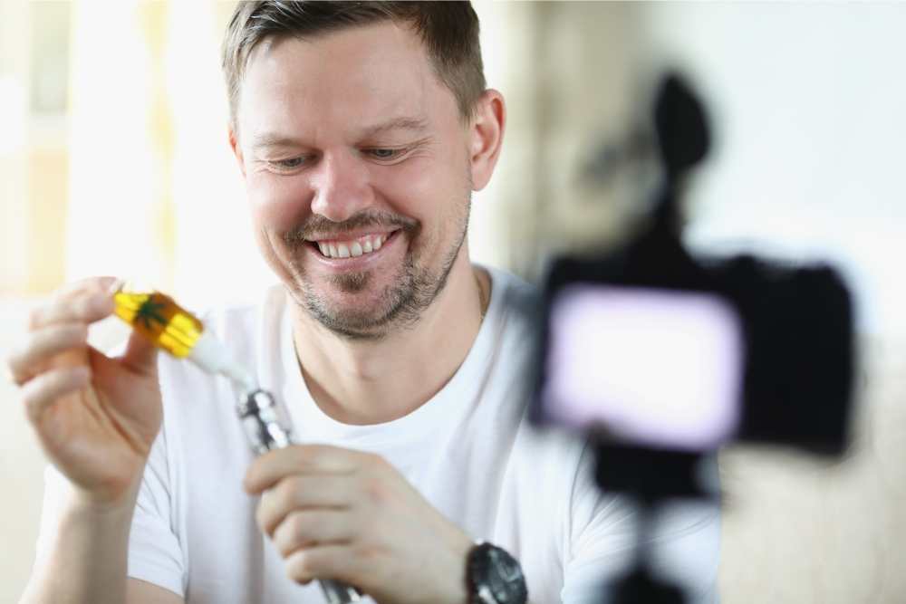smiling man using cbd oil