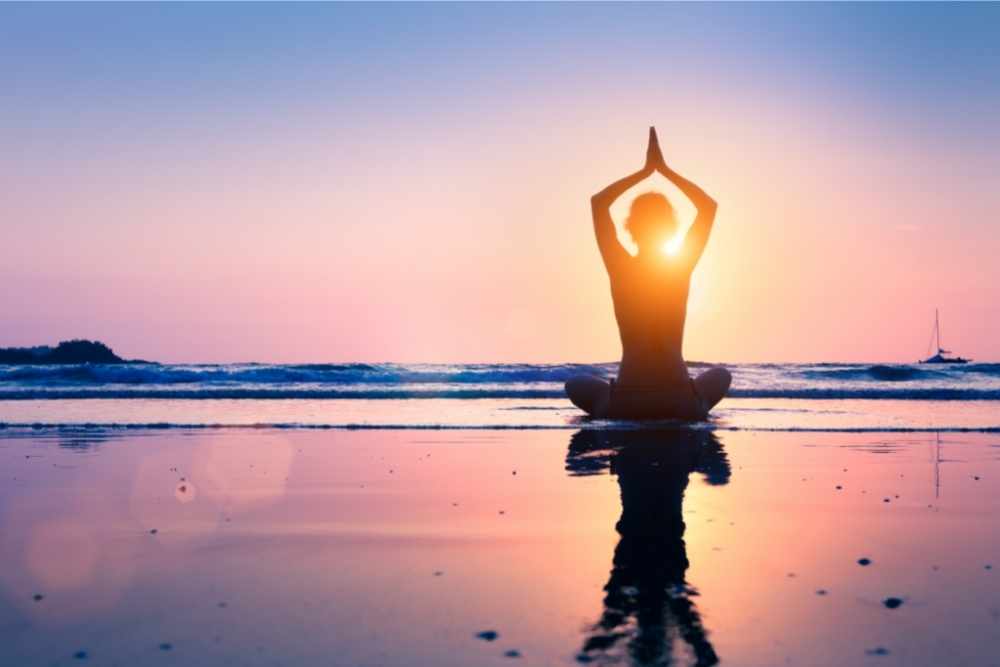 doing yoga by the beach