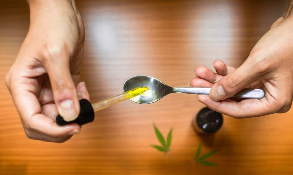 dropping cbd oil into a spoon