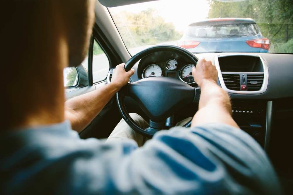 man driving a car