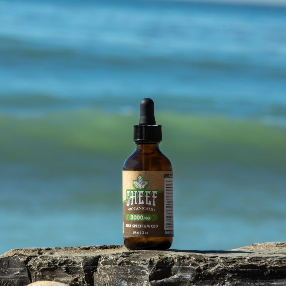 cbd oil on a rock by the beach