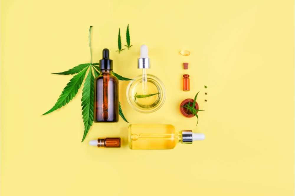 cbd oil bottles on yellow background