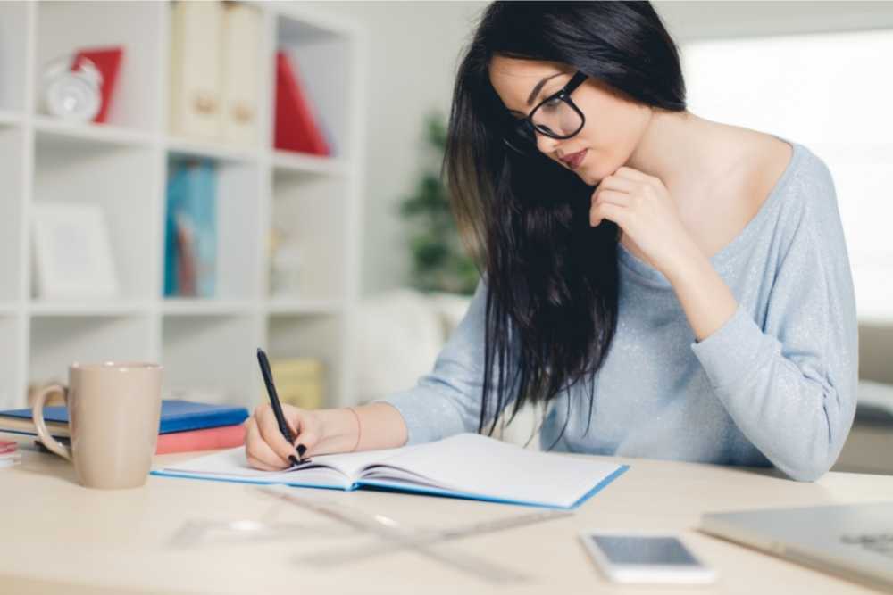 woman writing in notebook