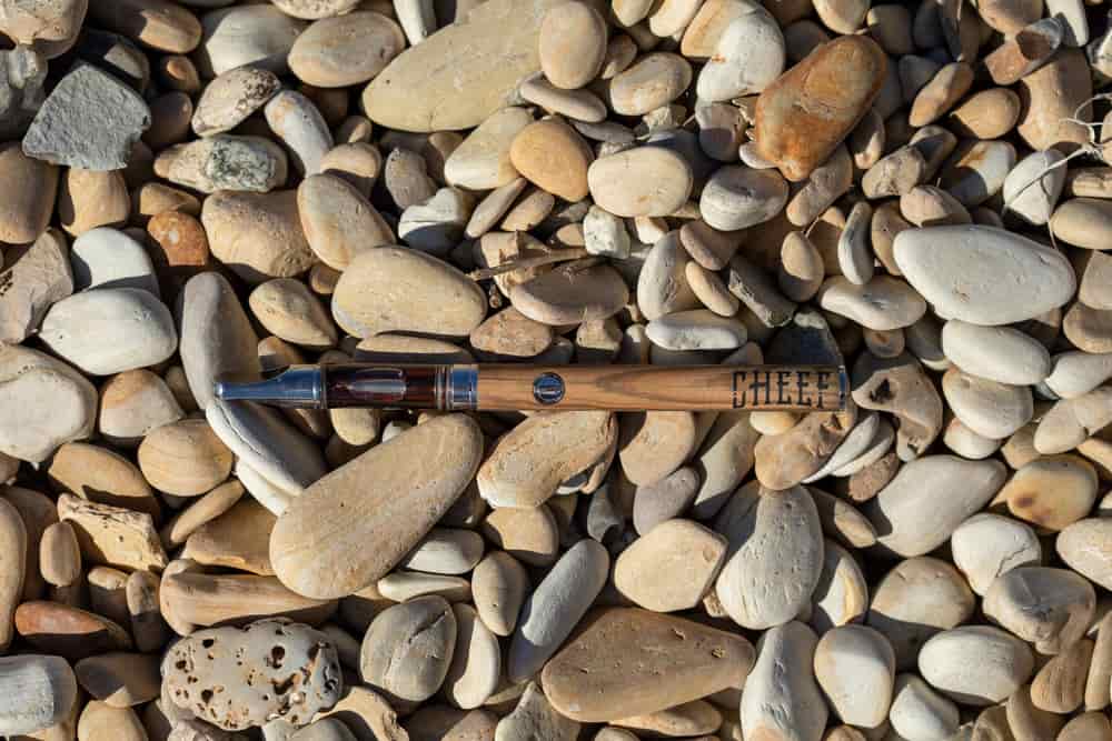 cbd pen on beach rocks