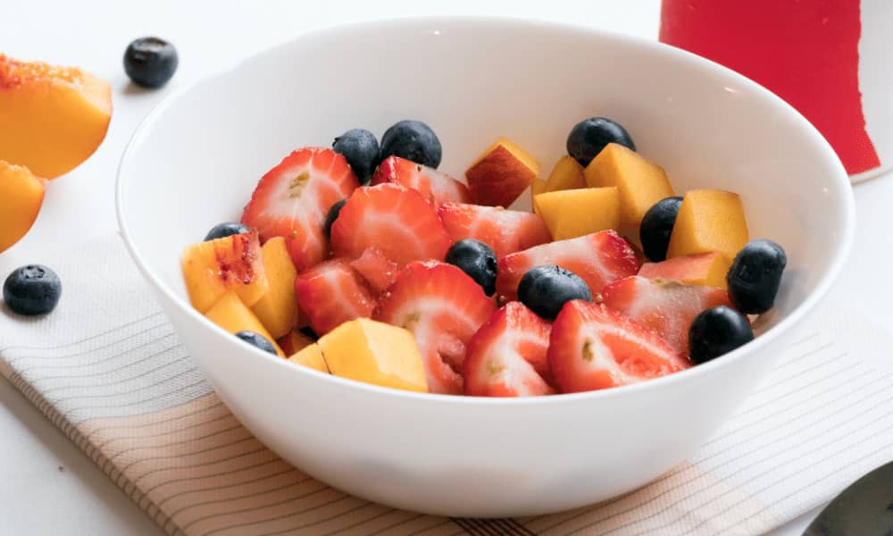 chopped fruit in a white bowl