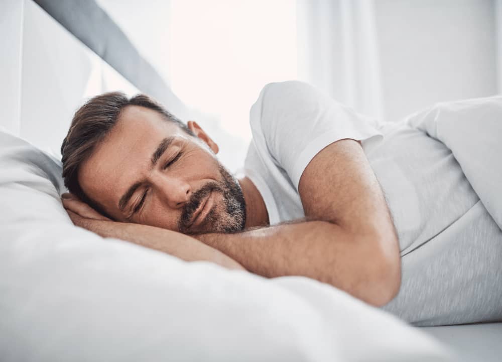man with beard sleeping comfortably