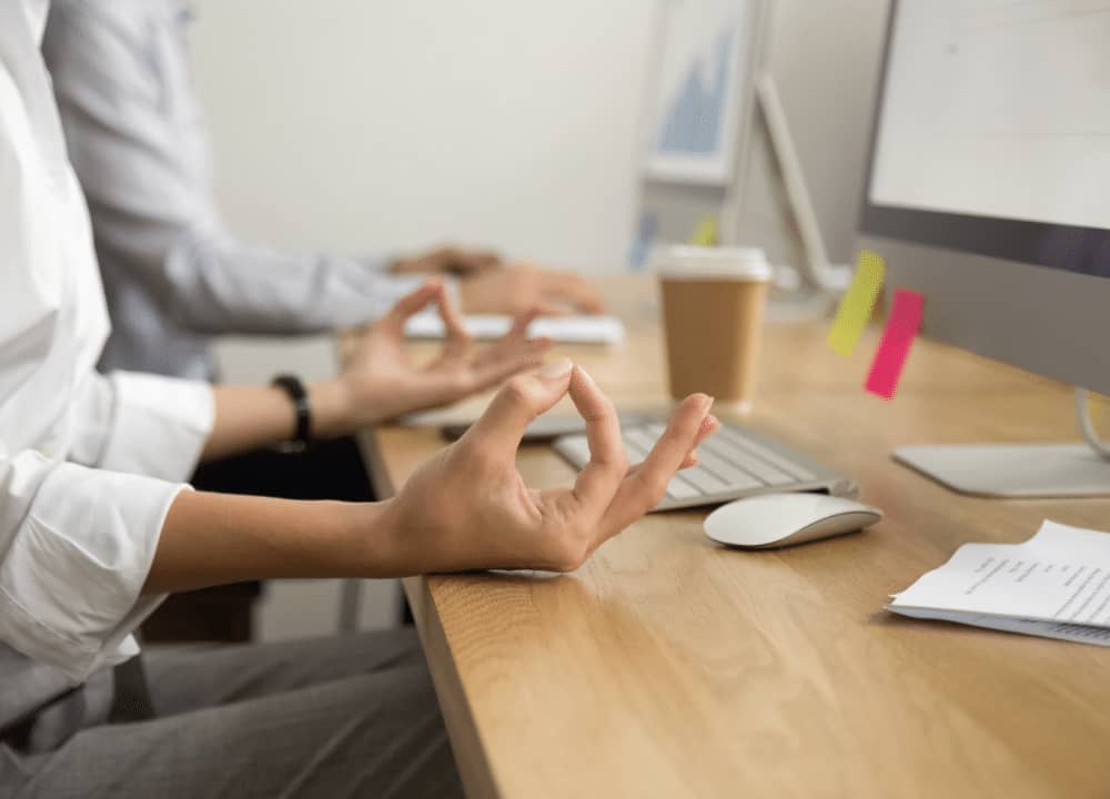 woman meditating at her computer