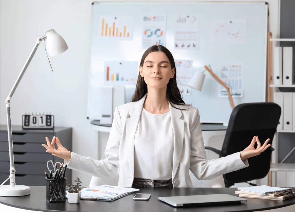 woman meditating at her desk