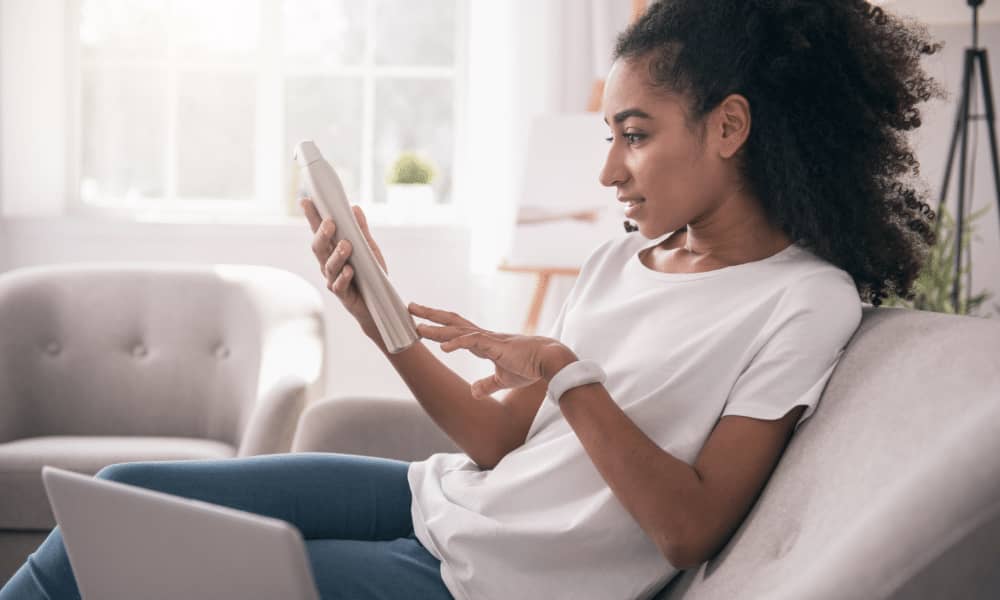 woman on couch reading ingredients