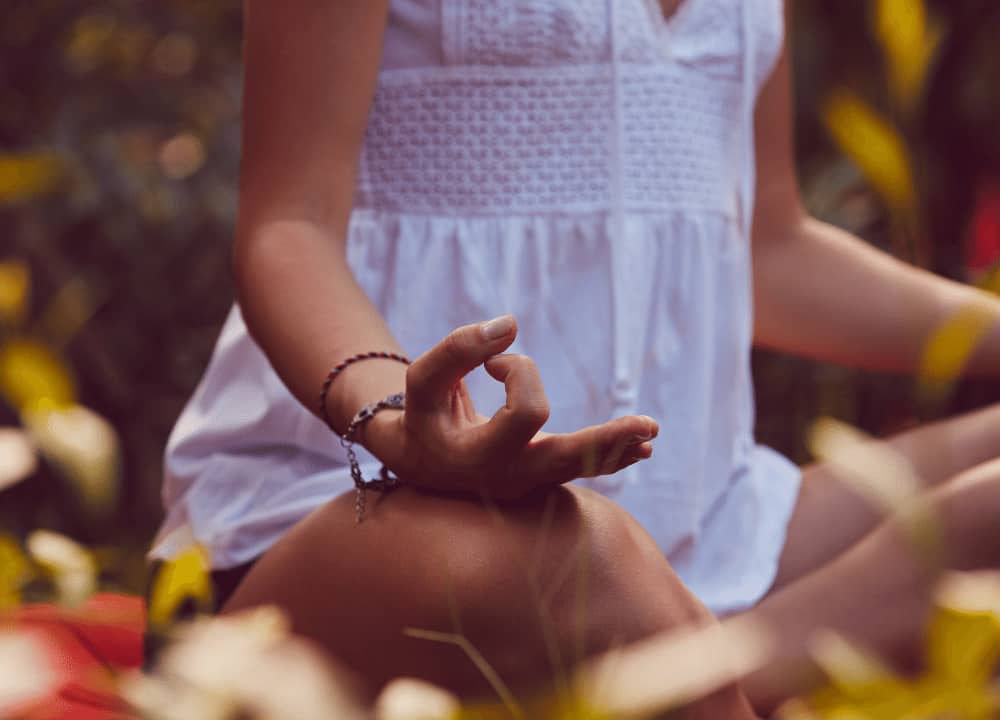 woman peacefully meditating in nature