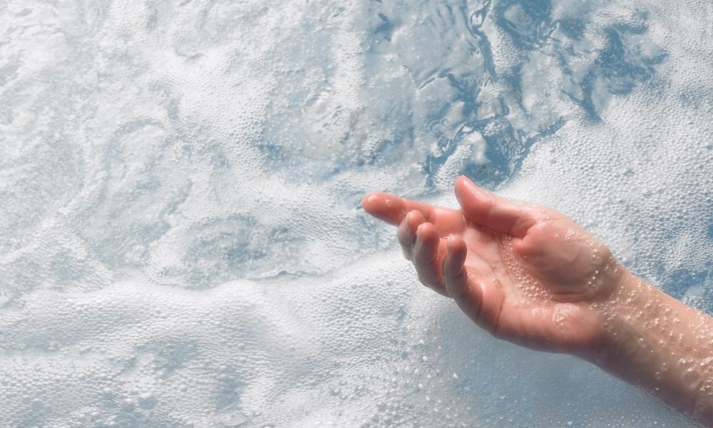 hand testing out bath water