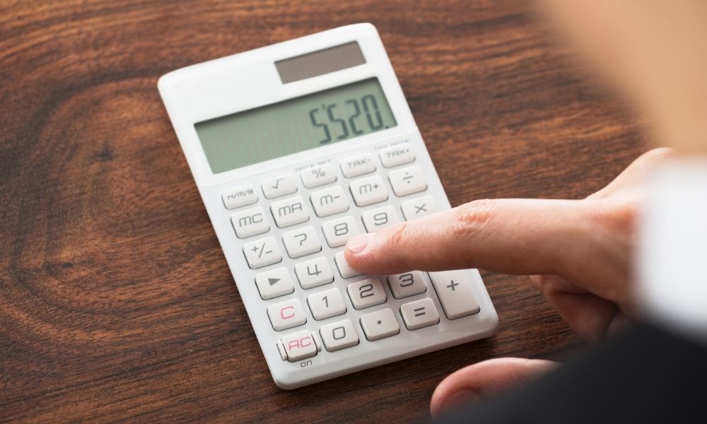 person using a small calculator