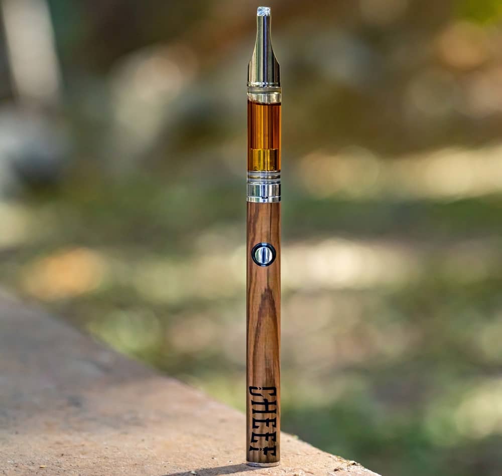 standing vaporizer pen on table