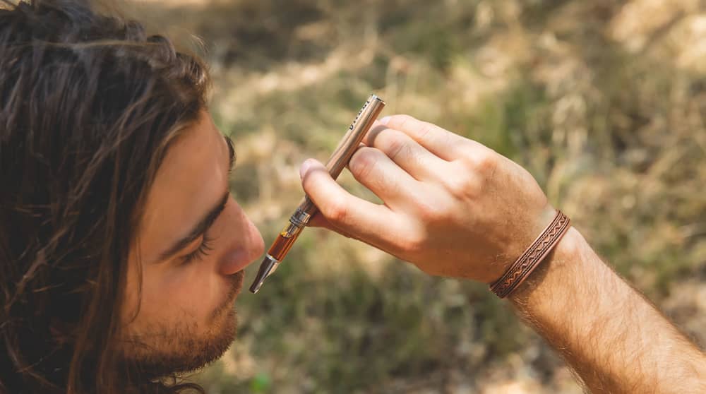 man vaping in the woods