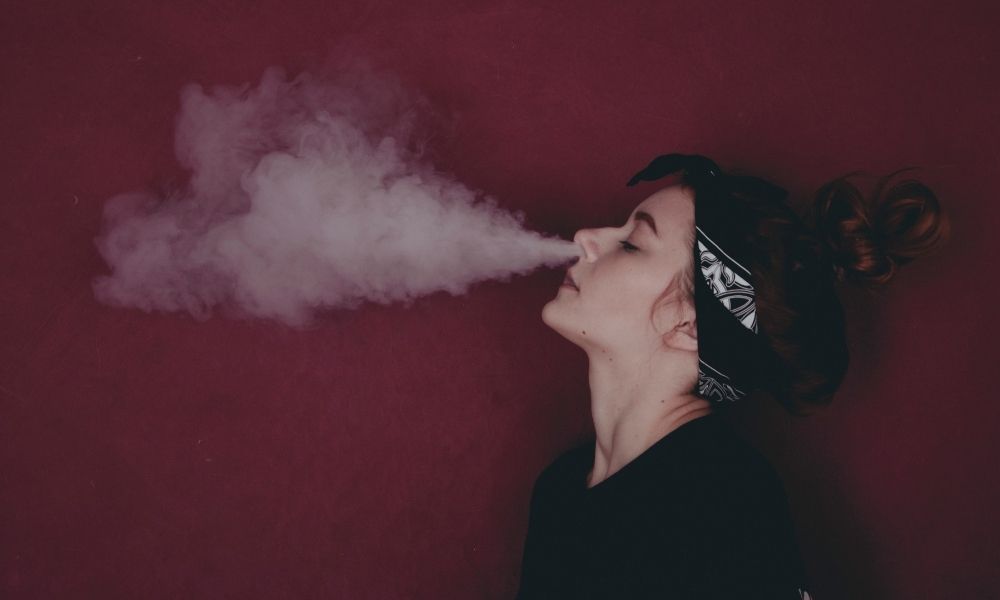 woman exhaling smoke from her nostrils