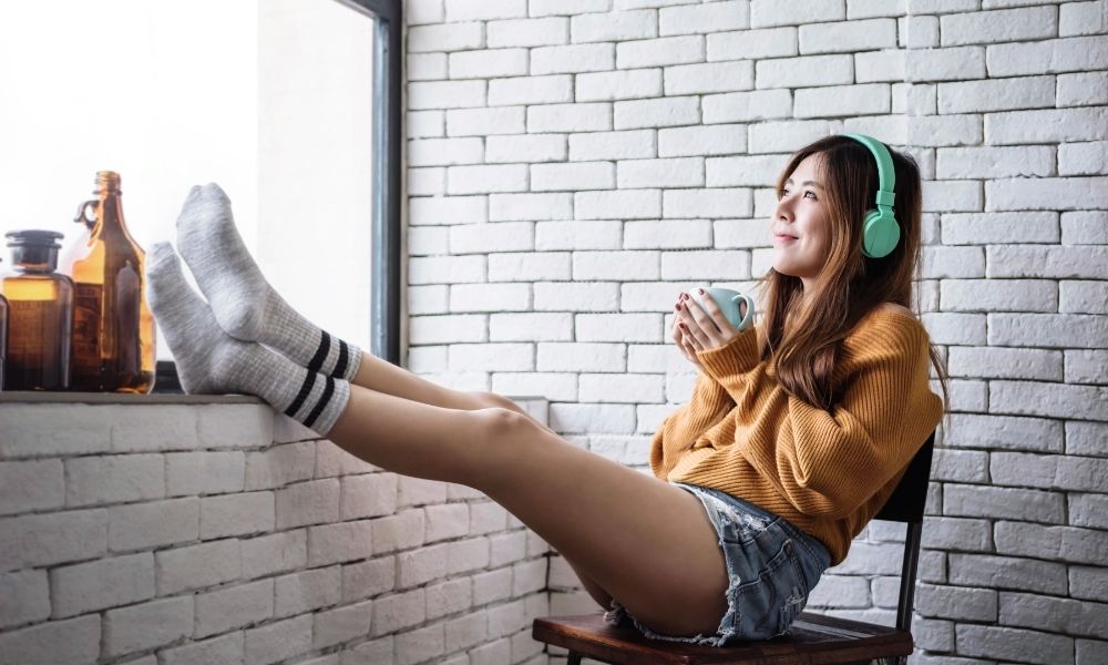 woman with green headphones relaxing