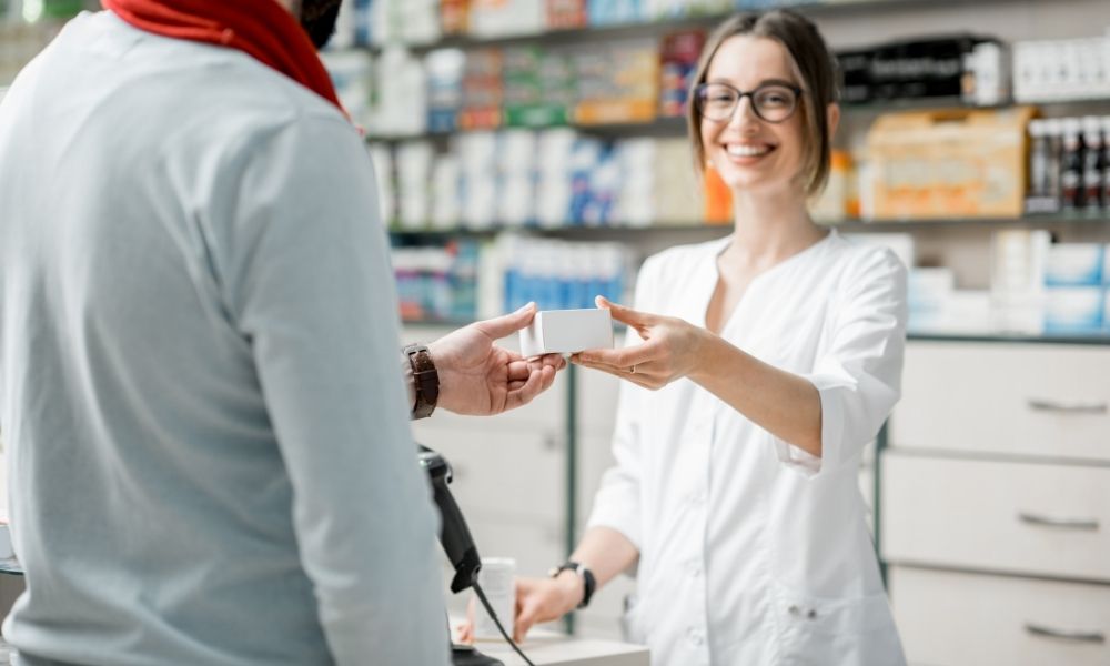 a woman selling tablets to man