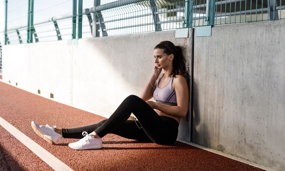 woman resting on track