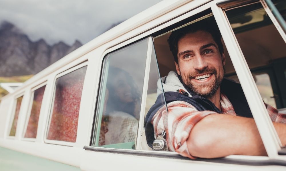 happy man sitting in car