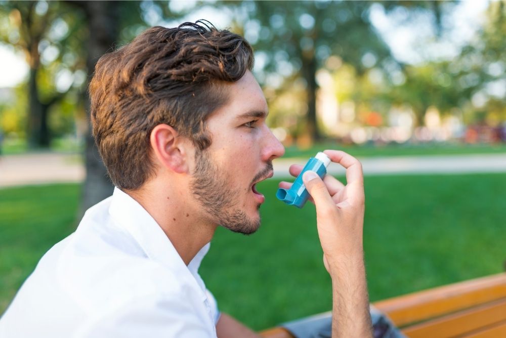 man opening mouth for his inhaler