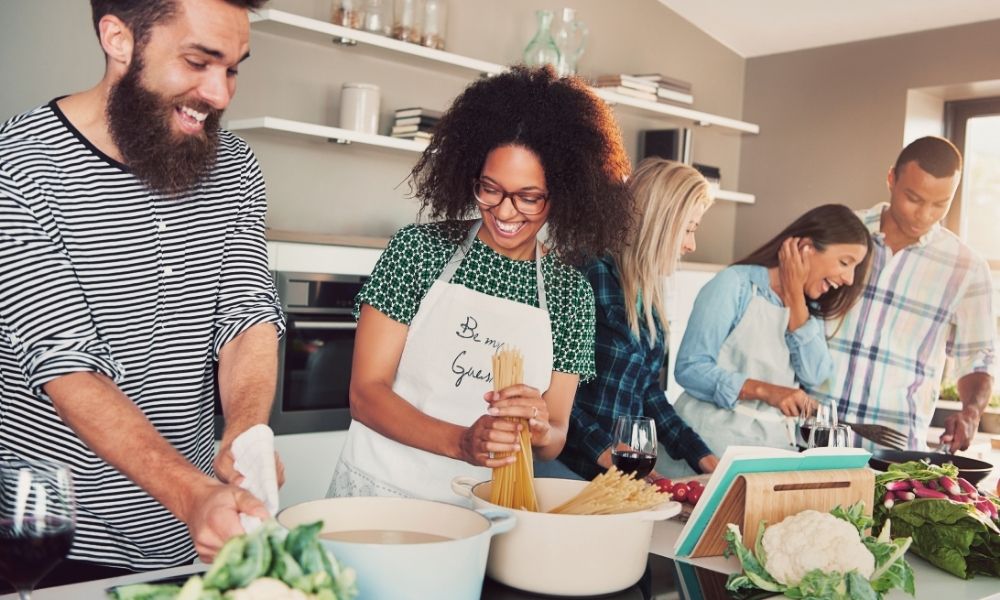 people having fun making food together