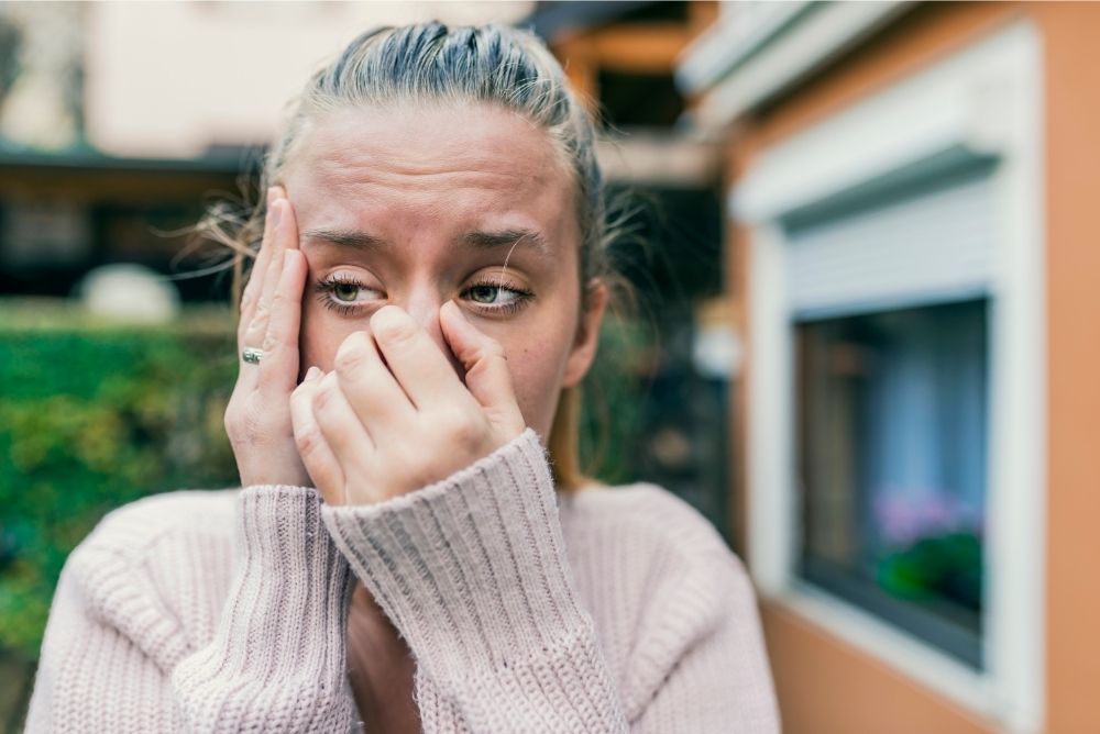 woman holding big sneeze