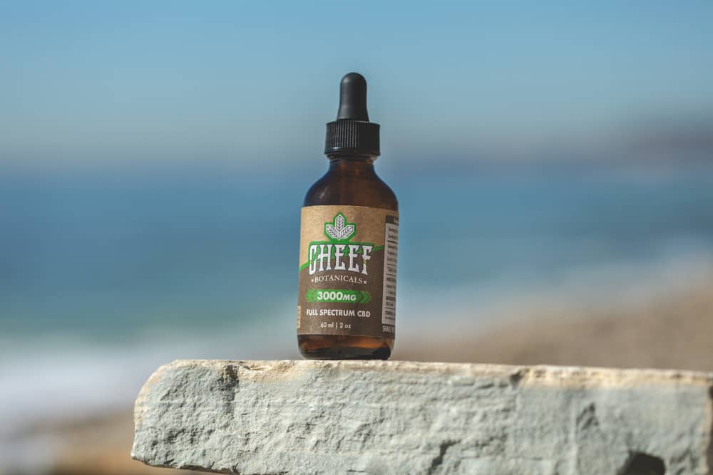 cheef cbd oil bottle on rock