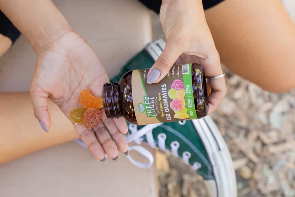 woman holding cbd gummies in her hand