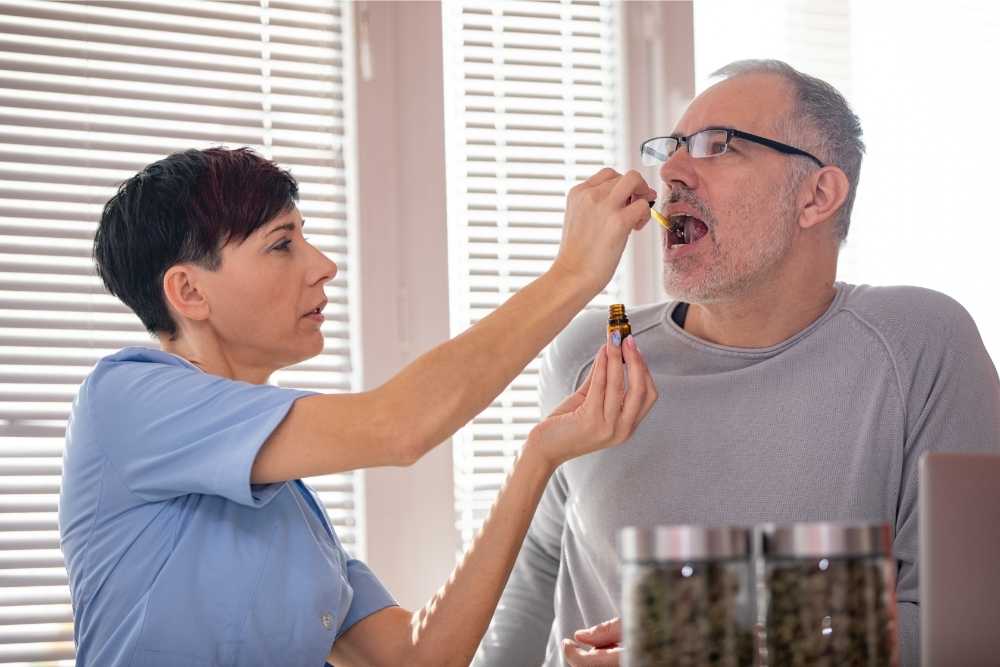 woman dropping oil under tongue for man