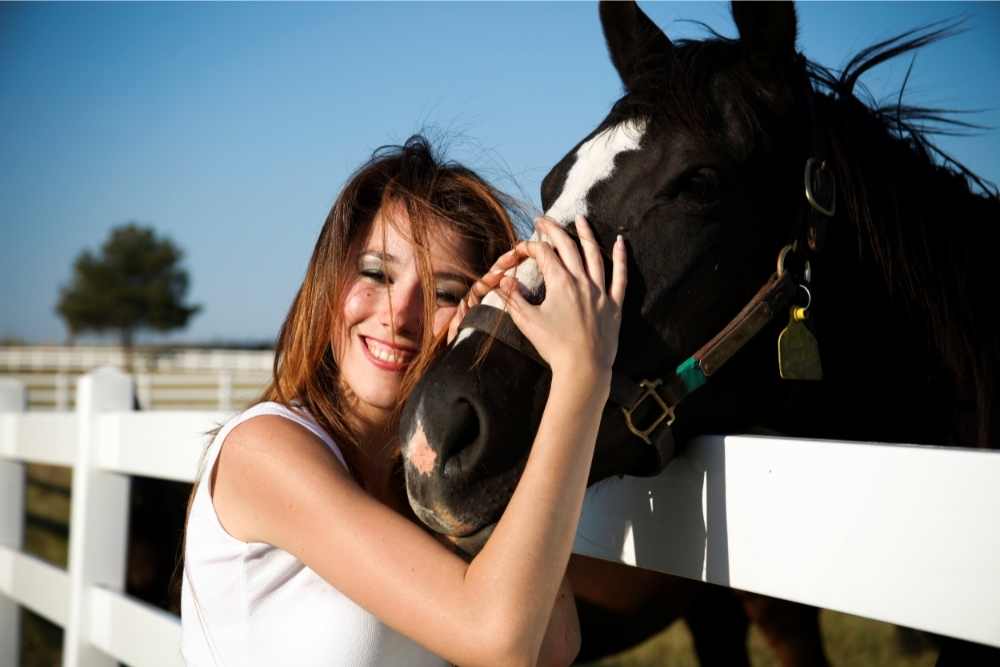 woman hugging her horse