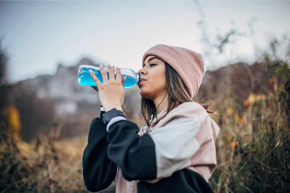 young woman drinking energy drink with CBD
