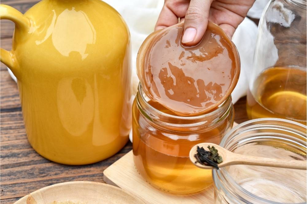 kombucha-being-mixed-by-hand