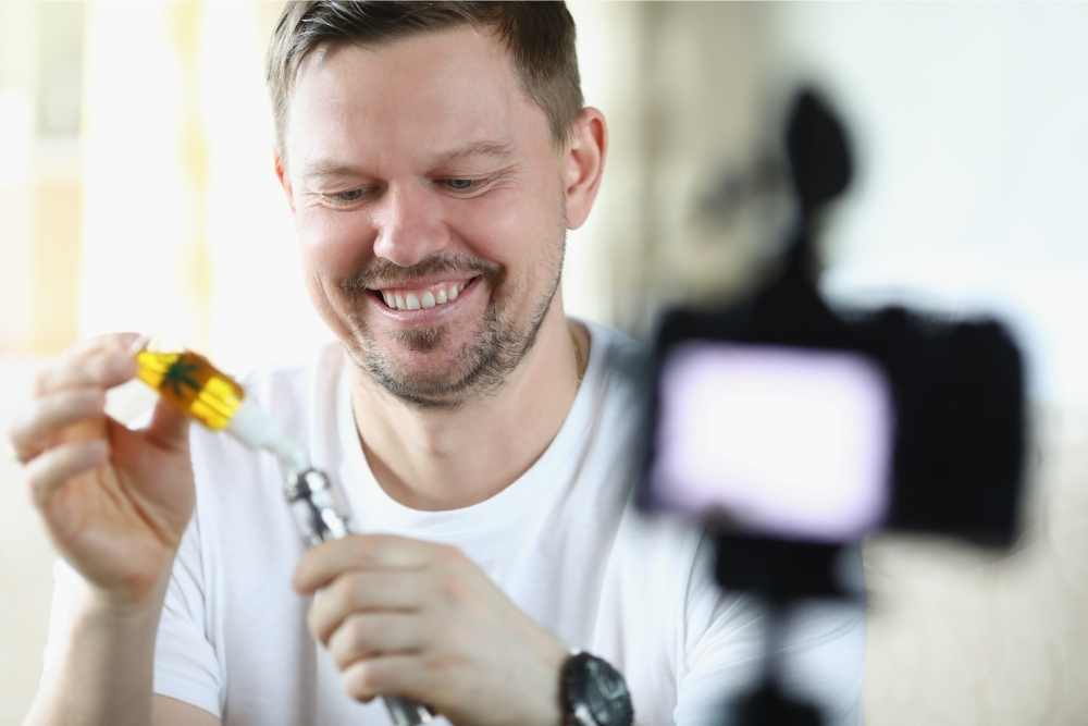 happy man refilling cbd vape