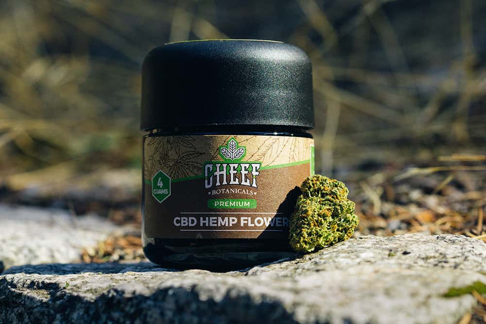 jar of cheef cbd hemp flower on rock