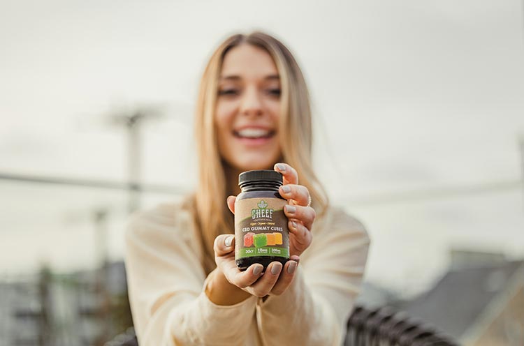 woman holding cbd gummy cubes