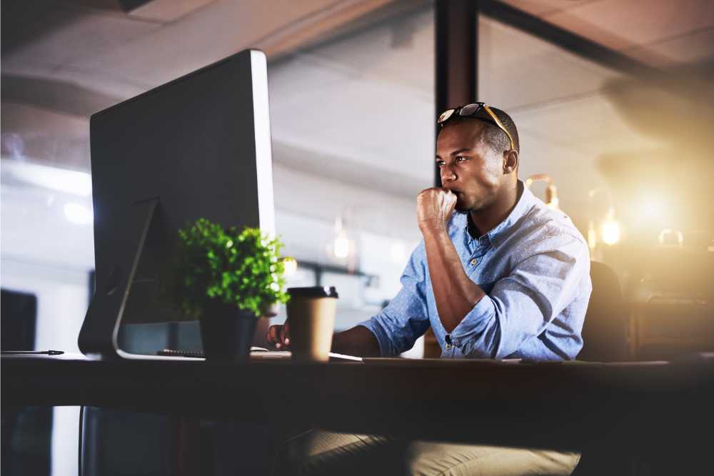 man on delta-10 focused sitting at desk working