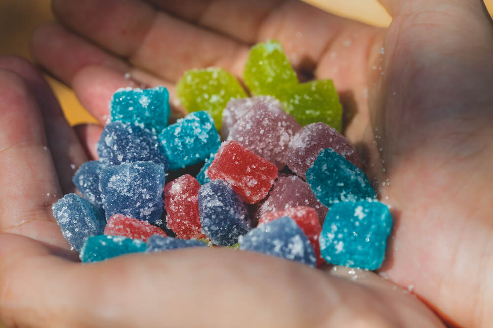 person holding gummy cubes