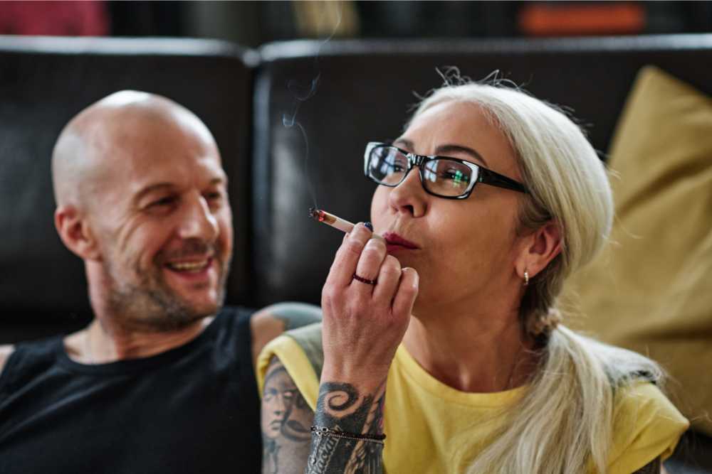 man and woman enjoying smoking thca delta-9 flower